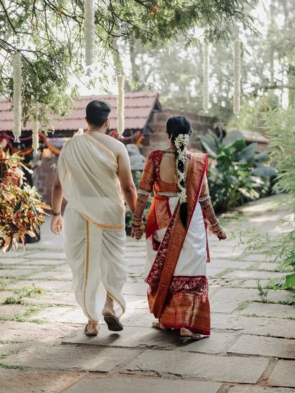 Walking into their future together. This back shot of the couple holding hands as they walk down a path is a beautiful and symbolic portrait of the start of their new journey.