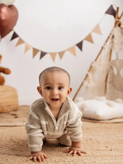 The first birthday is such a huge milestone! This little one was so excited to crawl and explore my boho-themed setup, complete with a mini teepee and "One" sign. These sessions are all about capturing their budding personality.