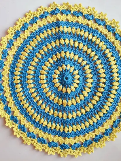 I made this blue and yellow doily as a prayer for peace. The colors are inspired by the Ukrainian flag, and the puff stitches create a lovely floral-like texture.