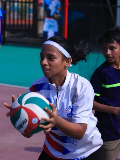 A young athlete at our camp, focused on setting the ball. We welcome players of all ages and skill levels.