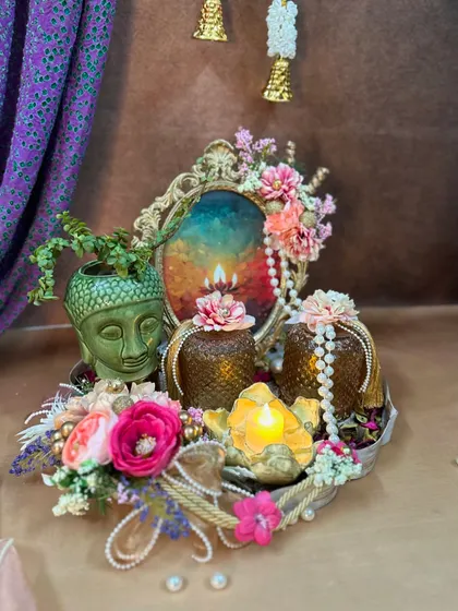Another view of the serene Buddha hamper, showcasing the intricate details of the vintage frame and the pearl strings adorning the jars.