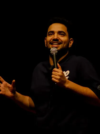 A beautifully lit close-up of Samay Raina interacting with the audience. We ensure even in large venues, the artist's expressions are clearly visible.