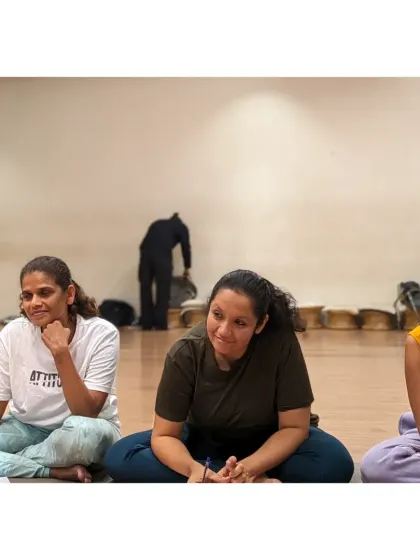 Students sit together, listening and sharing in a circle. Our movement therapy sessions always include time for reflection and connection.