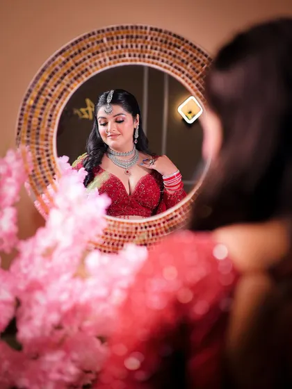 A creative shot using a mirror to capture the bride's reflection, adding depth and a unique perspective.