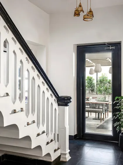 When working with a heritage property, I honor its history. I restored this original staircase, accenting the intricate handrail with a bold black finish and adding patterned tiles to the risers, celebrating the building's soul while giving it a new life.