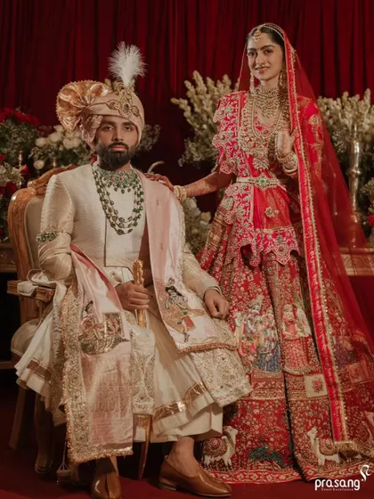 A wedding portrait is a legacy. I work with the finest photographers to stage and capture regal moments like this, ensuring the couple's attire, the opulent floral backdrop, and the overall composition reflect a story of timeless elegance.