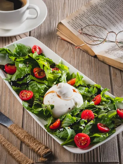Fresh, creamy, herby goodness on a plate. Our Burrata salad is the perfect starter to pair with your slice.