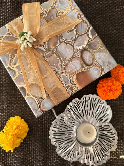 A silver floral T-light holder paired with an agate-print gift box. The combination of textures and patterns makes this a very stylish and modern gift.