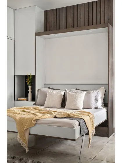 The Murphy bed is shown here partially unfolded, revealing the easy-to-use mechanism. This type of smart furniture is central to my design philosophy for making small spaces more livable and versatile.
