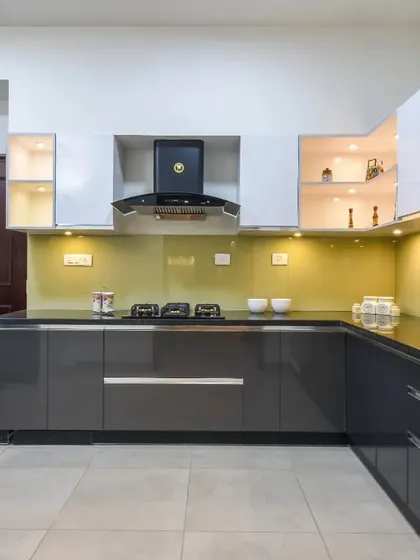 A full view of the U-shaped kitchen, demonstrating its practical layout and stylish two-tone color scheme.