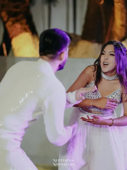 A fun, expressive moment from a high-energy couple's routine, capturing their personalities perfectly.