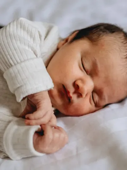 A close-up portrait of a sleeping newborn, highlighting their delicate features. We use soft, natural light to create gentle and beautiful images.