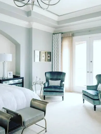 An elegant and grand bedroom featuring a cool grey palette. We advised on using subtle variations in tone on the walls and ceiling to create architectural depth.