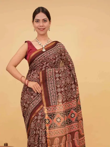 A rich maroon printed saree, pre-stitched for a perfect drape. This color is universally flattering and suitable for a wide range of occasions, from festive gatherings to formal dinners.
