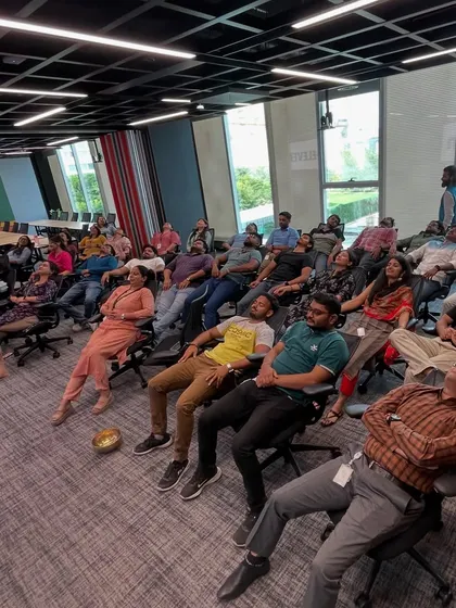 Employees of 7-Eleven enjoying a moment of deep relaxation in their office chairs.