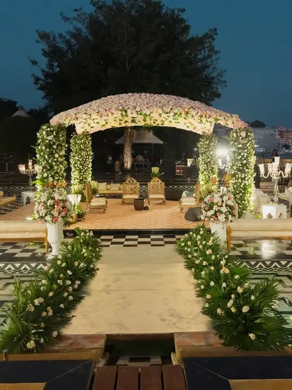I transform royal palace courtyards into dreamlike wedding venues. This stunning floral mandap at The Leela Palace Udaipur, set against the water, showcases my ability to blend natural beauty with opulent design for a destination wedding.