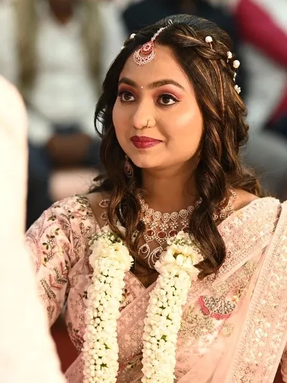 A candid shot from the engagement ceremony. Her makeup looks fresh and beautiful as she looks at her partner.