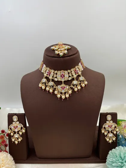 This collection showcases our premium Moissanite Kundan necklaces like the 'Noor Nazaakat' and 'Darbaar' sets. Each comes with a full set of earrings and maang tikka, available in various color combinations.