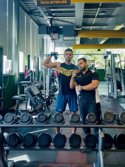 A member and his coach, Robin, pose after a successful session. This image captures the partnership and camaraderie we foster between our trainers and members on their fitness journey.
