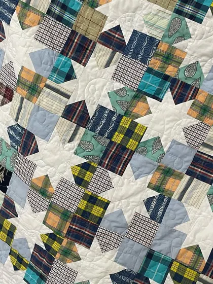 A close-up of the star blocks, showing how different shirt patterns are combined within a single block.