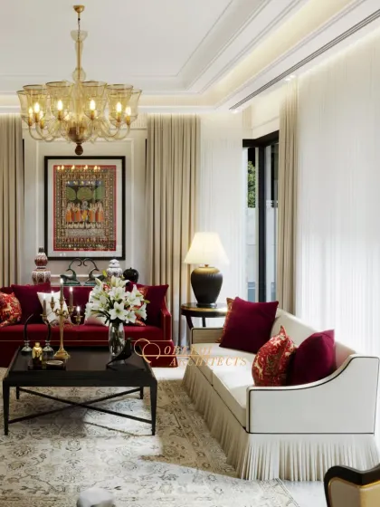 The space is anchored by a traditional Pichwai painting and a grand chandelier, blending cultural art with classic European design elements.