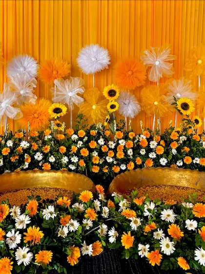 A close-up of our sunflower-themed Haldi decor, showing the rich texture and color of the fresh flowers surrounding the ceremonial brass pots.