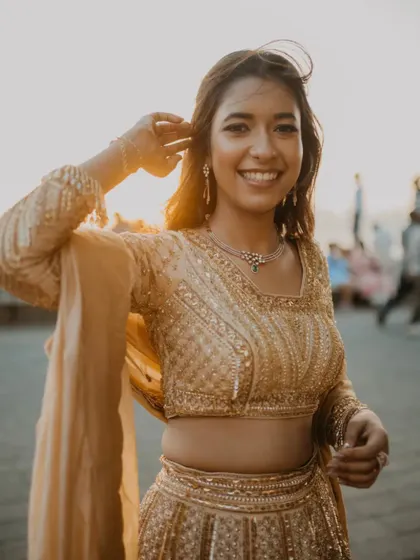 A beautiful, happy portrait of the bride-to-be at Marine Drive during golden hour. Her radiant smile and the wind in her hair capture a moment of pure joy.