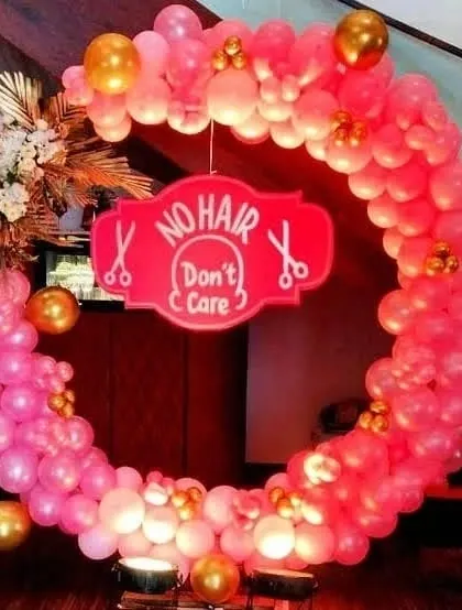 Here is another 'No Hair Don't Care' decoration, this time in pink and gold. This circular balloon arch is perfect for celebrating a baby's mundan ceremony in style.