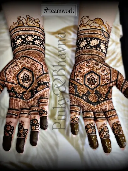 A lovely design featuring a central lotus motif, surrounded by geometric and floral patterns. The baby figures on the wrist add a personal touch for a baby shower.