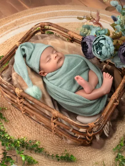 Another angle of the sweet newborn in the mint green swaddle and basket. The overhead shot shows how tiny and perfect they are.
