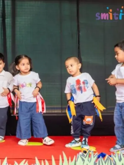 Four young children perform a dance routine together on stage. Learning choreography helps develop their memory, coordination, and ability to work in a group.
