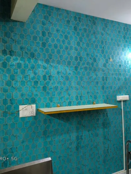 A vibrant teal wallpaper with a gold-embossed honeycomb pattern. The metallic details add a touch of luxury.