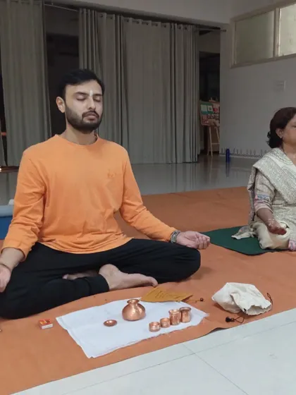 Two participants sit side-by-side in meditation, sharing the sacred space during a Bhuta Shuddhi session.
