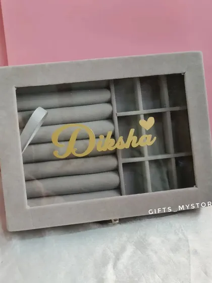 A personalized jewelry organizer with her name in gold. It's a stylish and practical gift that she can use every day.