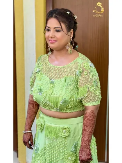 A portrait of my happy client, her floral braid perfectly matching her vibrant green outfit.