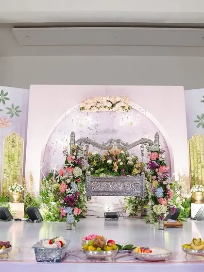 A slightly different angle of the naming ceremony stage, showing the beautiful layers of flowers and greenery. The soft lighting and delicate details made this a perfect setting to welcome a new life.