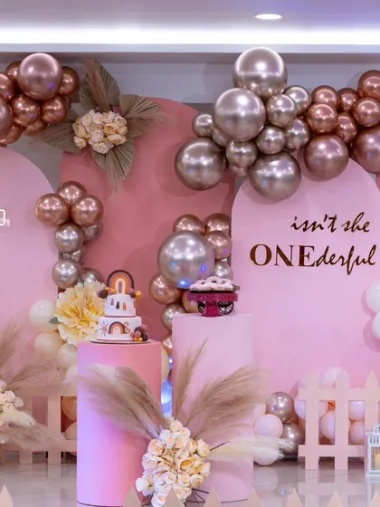 A different angle of the "ONEderful" princess party, highlighting the metallic balloon garland and boho-chic pampas grass details that give the classic theme a modern twist.