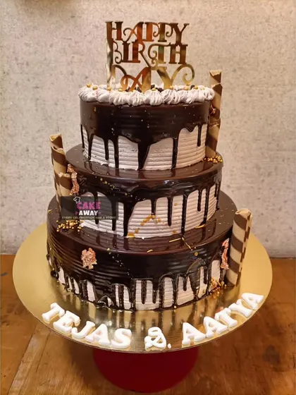A grand three-tier chocolate drip cake. This towering creation is perfect for large birthday parties or events, combining classic looks with indulgent flavor.