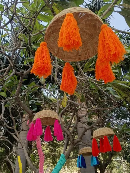 A cluster of hanging baskets with orange and pink tassels. Mixing and matching colors allows me to create a decor theme that is both cohesive and visually dynamic.
