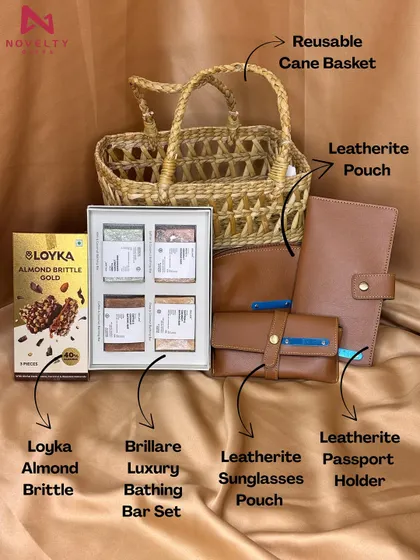 For a more rustic and eco-conscious feel, I offer hampers like this one. It combines a reusable cane basket with premium leatherette accessories like a passport holder and a sunglasses pouch.