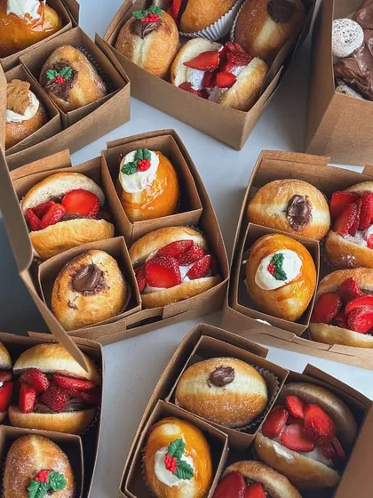 My festive Christmas bombolini boxes, featuring flavors like strawberry cream, Nutella, and holiday spice.