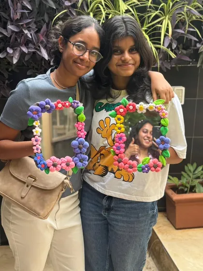 Two friends with their finished clay mirrors. One even has a photo in it already. It's a great way to frame your favorite memories.