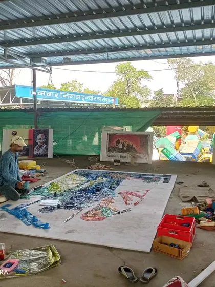 Artist Sunil Vyas is seen here working on a large-scale mosaic made from plastic waste. His work, part of the Swachh Bharat Abhiyan, transforms discarded materials into incredible art, promoting a message of sustainability.