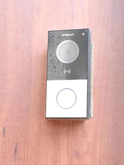 A close-up of our sleek, modern video doorbell. It features a high-definition camera and a backlit button, making it easy for visitors to use day or night.