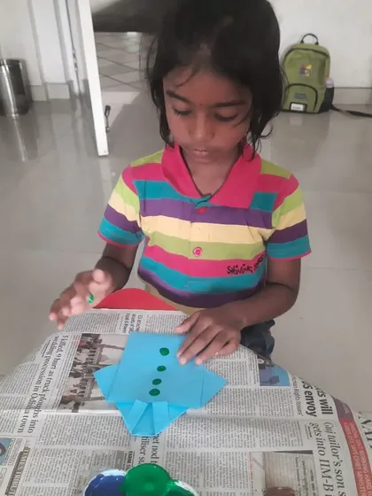 A student carefully works on her Father's Day card, a beautiful example of the love and effort our children put into their creations.
