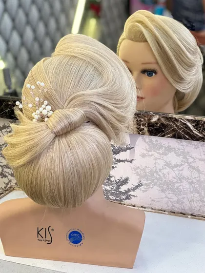 A still shot of the elegant low bun with a side-swept front, showing the beautiful silhouette.