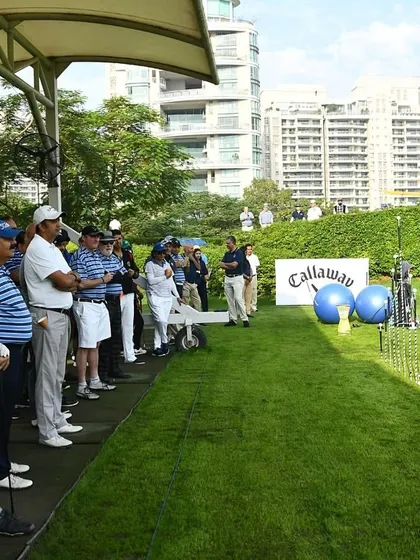 A Coach Instructing a Group of Adult Golfers: Our group lessons provide a dynamic learning environment. Here, a coach provides instruction to an attentive group of adult learners at our state-of-the-art driving range.