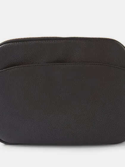 The back view of the black Australia Crossbody bag. It has a clean, simple look with rose gold hardware.