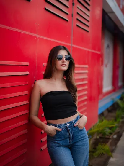 A duplicate of image 51, this classic street style portrait pops against the vibrant red industrial background.
