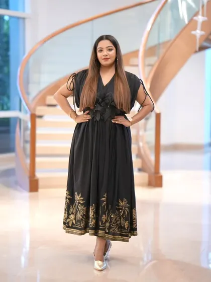 Full-length portrait in my black and gold dress for the R.D. Brothers Group event. The elegant staircase provided a beautiful backdrop that matched the upscale feel of the corporate launch.